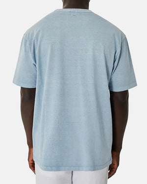 A person wearing the Industrie The Del Sur Tee, a light blue, 100% cotton oversized short-sleeve T-shirt, is shown from the back against a plain white background.