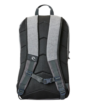 The Rip Curl Overtime 30L Driven Backpack is displayed from the back, featuring padded shoulder straps, a top handle, adjustable chest straps with a buckle, and a mesh padded back panel for comfort. Made from recycled polyester in gray and black, it's also laptop compatible for added convenience.