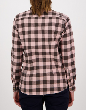 A person with long hair is shown from the back, wearing a Swanndri Women's Taranaki Tailor Shirt in 100% cotton, featuring pink and black checks with buttoned cuffs and a tailored fit. They pair it with dark pants against a plain white background.