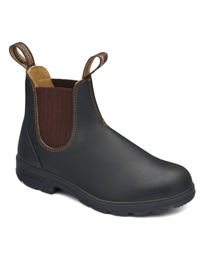 The Blundstone 600 Non Safety Elastic Sided Boot in black features brown elastic side panels, two pull tabs for easy wear, and a textured black sole. The interior lining is made of tan leather, providing added comfort and durability. The boot is showcased against a plain white background.