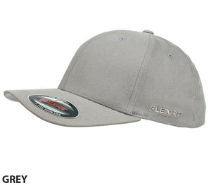 A grey FlexFit Worn By The World Cap with a slightly curved, contrast brim is shown. The stylish and comfortable cap features a sticker on the brim with product information and the Flexfit logo embroidered on the side. The background is plain white. The word "GREY" is written in black in the bottom left corner.