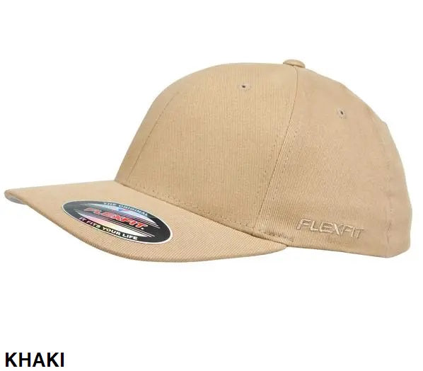 Introducing the FlexFit Worn By The World Cap: a stylish and comfortable khaki-colored cap with a flat brim and a small ventilation hole on top. The brim features a sticker that reads, "FLEXFIT THE ONE AND ONLY 110, Flexfit YOUR LIFE." The word "FLEXFIT" is embroidered on the left side for both style and brand recognition.