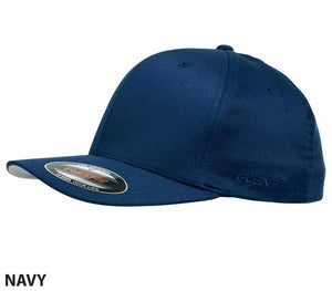 A stylish and comfortable FlexFit Worn By The World cap in navy blue is displayed at an angle, showcasing the front and side. The cap features structured panels, a curved brim, and a small stitched logo on the side. A sticker on the brim indicates the brand, size, and various features. The word "NAVY" is written below.