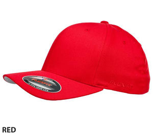 A stylish and comfortable bright red Flexfit Worn By The World Cap with a curved brim and a sticker on the front of the bill. The cap is plain with no visible logos or designs. The text "RED" is written at the bottom left corner of the image.