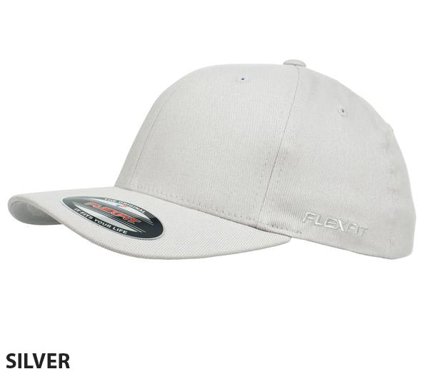 Here is the FlexFit Worn By The World cap, combining style and comfort in a polished silver hue. It features a curved contrast brim and a six-panel design with ventilation eyelets. The "Flexfit" brand logo is embroidered on the side, and the cap's sticker is visible on the front part of the brim.