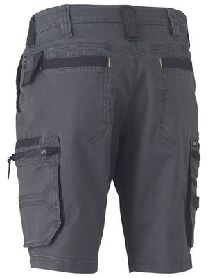 The Bisley Flex & Move Stretch Utility Cargo Short is designed for durability and comfort, featuring multiple pockets, including two rear pockets, a zippered side pocket, and a cargo pocket with a flap on the left thigh. These gray work shorts also boast reinforced belt loops and stitching details.