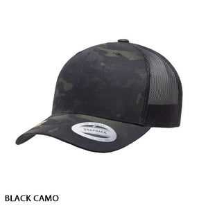 Introducing the FlexFit Retro Trucker Multicam Cap: a stylish black snapback cap featuring a curved brim and mesh back panels. This cap includes a sticker on the brim and is labeled "BLACK CAMO" in text at the bottom left of the image, embodying that classic Retro Trucker Cap aesthetic.