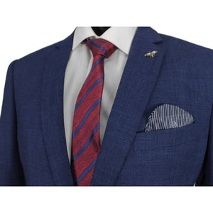 A person is wearing the stylish Scuzzatti Sports Jacket in blue over a white dress shirt, accessorized with a red and blue striped tie. The jacket also features a bee lapel pin and a blue and white striped pocket square, highlighting the skinny fit of the upper torso without revealing the person's face.