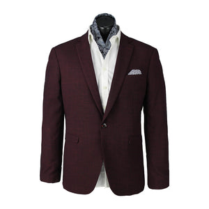The Scuzzatti Sports Jacket in burgundy, featuring a notched lapel, is displayed on a mannequin. This stylish jacket is paired with a white dress shirt and a patterned silk scarf tucked into the collar. With its contrast lining and skinny fit, it also showcases a patterned pocket square in the breast pocket.