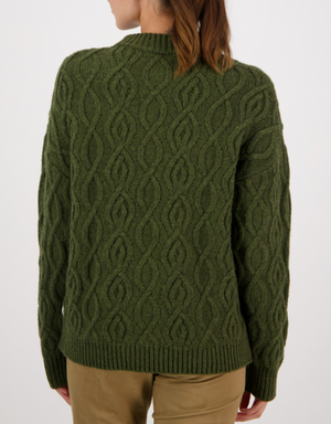 A person with brown hair is shown from the back against a plain white background, wearing an olive green Swanndri Pendeen Cable Neck Crew jumper with a chunky knit design and khaki pants.