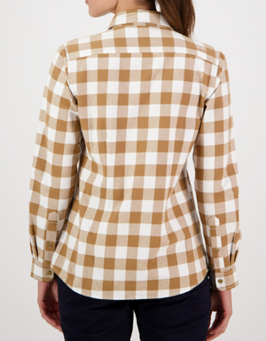 A person is seen from the back wearing the Swanndri Womens Taranaki Tailor Shirt, a long-sleeve tan and white checkered top, paired with dark pants against a plain white background.