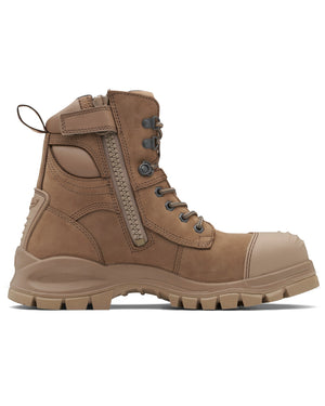 The Blundstone 984 Zip Sided Scuff Cap Safety Boot is a tan tactical work boot with a rugged, thick-soled design and detailed stitching. It includes metal eyelets, a side zipper for easy access, and a steel toe cap for protection. This boot boasts slip resistance, a pull tab at the back, and reinforced areas around the toe and heel for added durability.