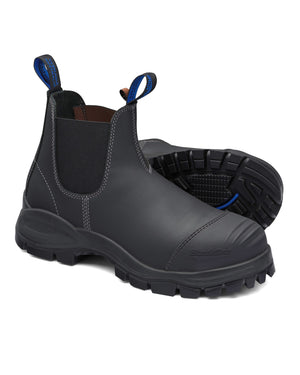 The Blundstone 990 Elastic Sided Scuff Cap Safety Boot is a pair of dark gray leather work boots featuring blue pull tabs, elastic sides, rugged textured soles for outdoor wear, water resistance, and visible edge stitching for style and durability.
