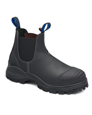 The Blundstone 990 Elastic Sided Scuff Cap Safety Boot is a black leather ankle boot with elastic side panels, a steel toe cap, sturdy tread, and blue pull tabs. It's water-resistant with a sleek yet rugged design, making it ideal for outdoor work.
