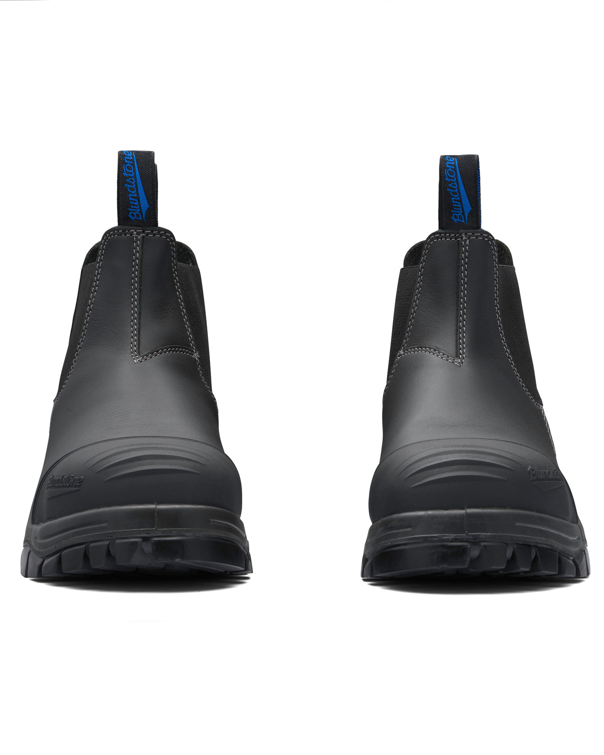 The Blundstone 990 Elastic Sided Scuff Cap Safety Boot is a sturdy, black work boot with prominent stitching and blue pull tabs. With thick, rugged soles for durability, these water-resistant boots feature a steel toe cap and are positioned side by side, facing forward.