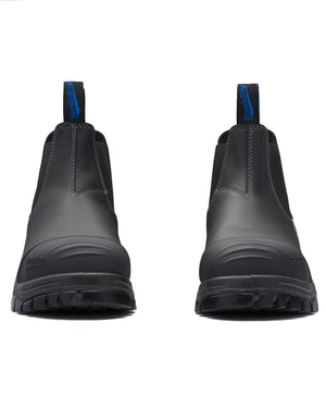 The Blundstone 990 Elastic Sided Scuff Cap Safety Boot is a sturdy, black work boot with prominent stitching and blue pull tabs. With thick, rugged soles for durability, these water-resistant boots feature a steel toe cap and are positioned side by side, facing forward.