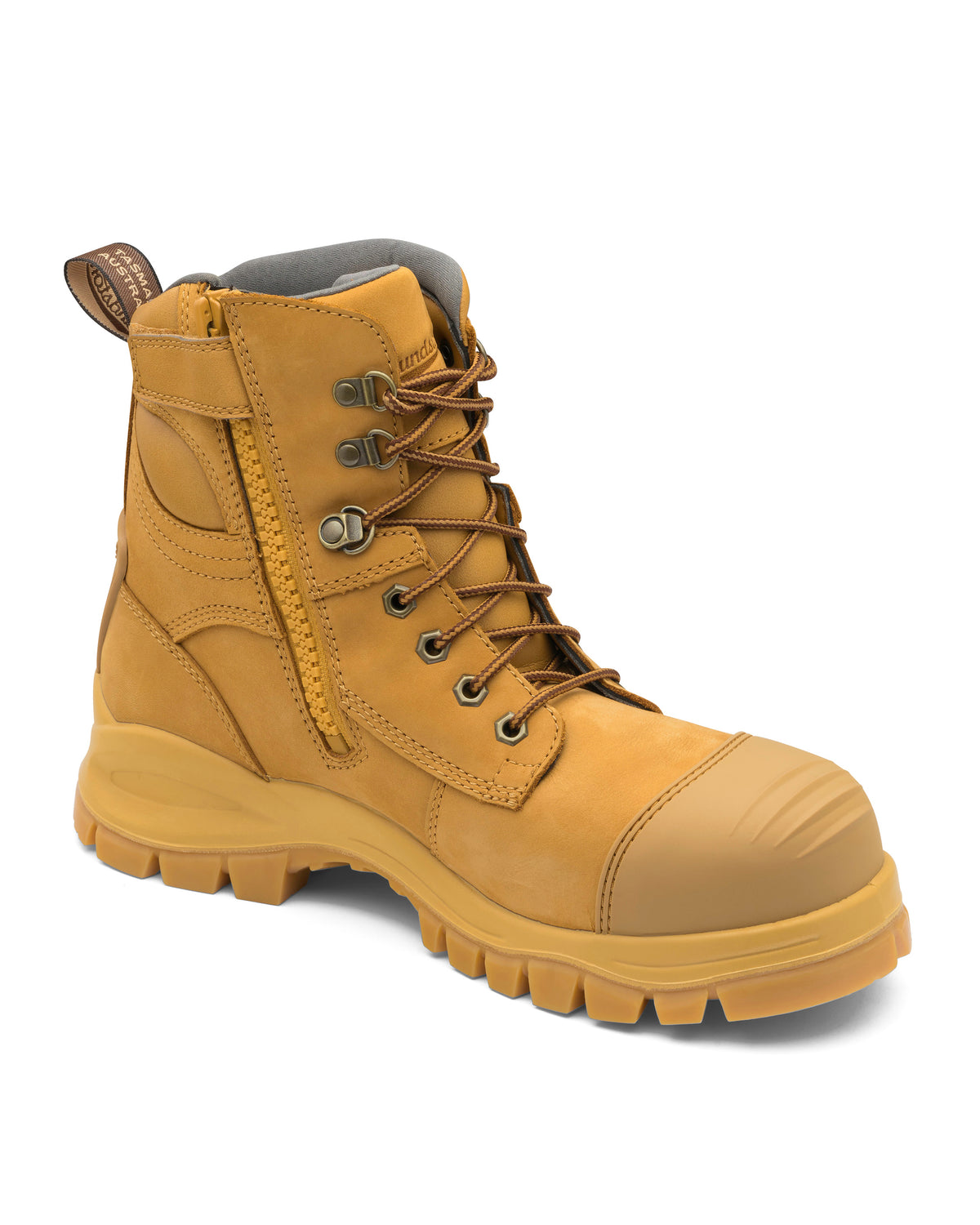 The Blundstone 992 Zip Sided Scuff Cap Safety Boot is a single tan work boot featuring black laces and a convenient side zipper. It boasts a rugged, reinforced steel toe cap and a thick sole with deep traction grooves. Water-resistant and sturdy in appearance, this boot is engineered for heavy-duty use, offering excellent ankle support and durability.