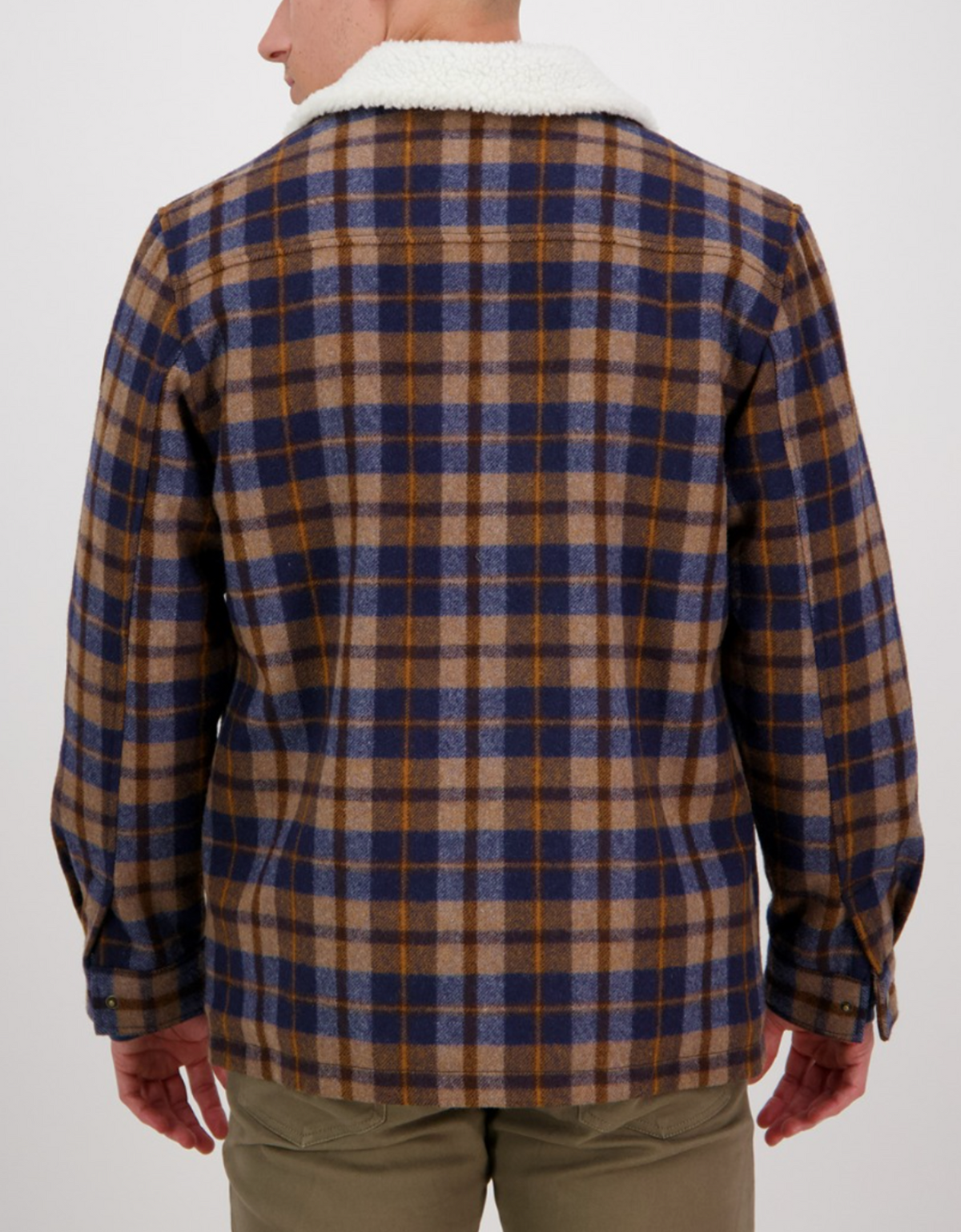 A person is shown from the back wearing the Swanndri Kaituna Sherpa Lined Jacket in blue, brown, and beige plaid with a white sherpa collar. They are also wearing khaki pants and have their hands relaxed at their sides.