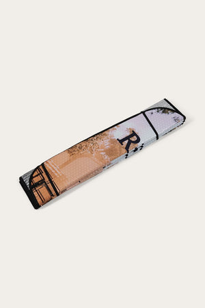 A folded, rectangular yoga mat featuring an abstract mix of colors—shades of brown, white, and black—with a printed design that includes partial images of a tree and architectural elements. The mat is displayed against a plain background similar to the Ringers Western Eclipse Car Windscreen Shade.