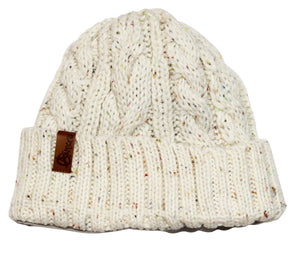 The Anticorp Ladies Twist Lined Beanie is a white knitted hat adorned with colorful speckles and a folded brim. It boasts a brown leather patch on the brim with an embossed logo, showcasing a cable knit pattern and enhanced with a soft fleece lining for added warmth.