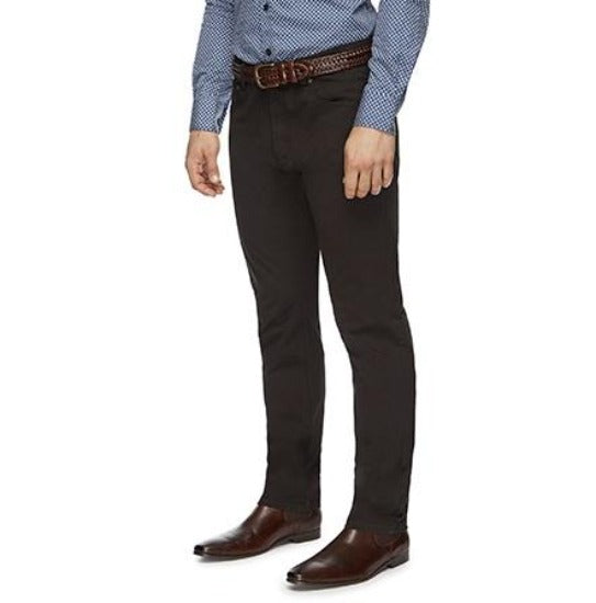 A person wearing a blue and white checkered shirt paired with the City Club Austin Road Pant, complemented by a brown woven belt and brown leather shoes. This City Club member exudes effortless style, shown from the shoulders down with hands relaxed at their sides.