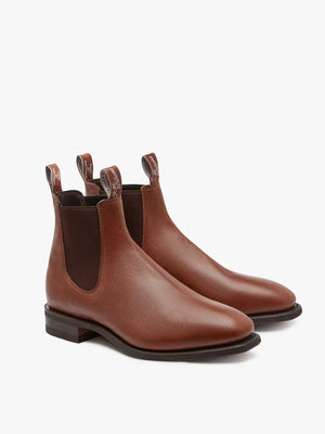 The RM Williams Comfort Kangaroo Craftsman Boot is a pair of brown Chelsea boots made from kangaroo leather, featuring elastic side panels and pull tabs on both the front and back. Their sleek design includes a low stacked heel, chisel square toe, and comfort innersole, making them suitable for both casual and formal wear.