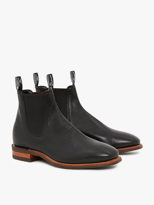 The RM Williams Comfort Kangaroo Craftsman Boot is a pair of sleek black Chelsea boots handcrafted in Australia, featuring wooden soles, elastic side panels, and pull tabs at the back for easy wearing.