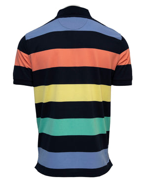 The Back Bay Multi Block Stripe Polo is a casual shirt with wide horizontal stripes in dark blue, light blue, orange, yellow, and green. It features short sleeves and a classic collar.