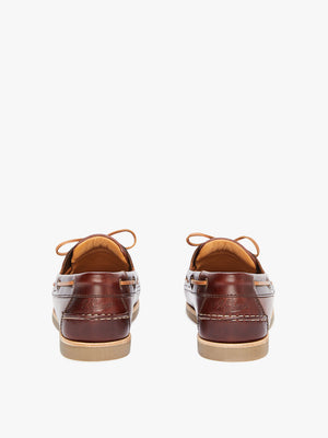 A rear view of the RM Williams Hobart Boat Shoe in brown yearling leather, showcasing tan laces, light tan rubber outsoles, stitching detail, and embossed branding on the heel.