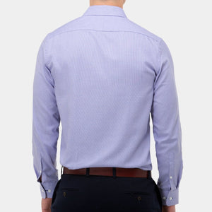 A person wearing a light blue, long-sleeved Brooksfield Micro Textured Shirt and dark pants is shown from the back. The stylish shirt is tucked into the pants, which have a brown belt. The background is plain and white.