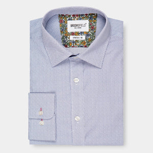 A neatly folded Brooksfield Stretch Print Shirt, long-sleeve and button-up in light blue with a subtle textured pattern. The inner collar and cuffs feature a colorful floral design. The tag reads "BROOKSFIELD" and "STRETCH / 40". This regular fit shirt is displayed on a plain white background.