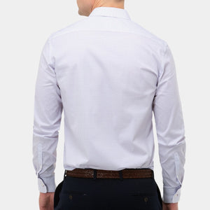 A man is shown from behind, wearing a stylish Brooksfield Stretch Print Shirt with a subtle dotted pattern. The shirt is neatly tucked into dark navy pants, secured with a brown woven leather belt. The background is plain and unobtrusive, emphasizing the clothing.