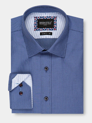 A stylish, folded long-sleeve, blue checkered dress shirt with a contrasting white and blue interior pattern. Made from 100% cotton, the "Brooksfield Luxe Textured Shirt" label at the collar inside indicates a slim fit and size "40". The shirt is finished with dark buttons for an elegant touch.