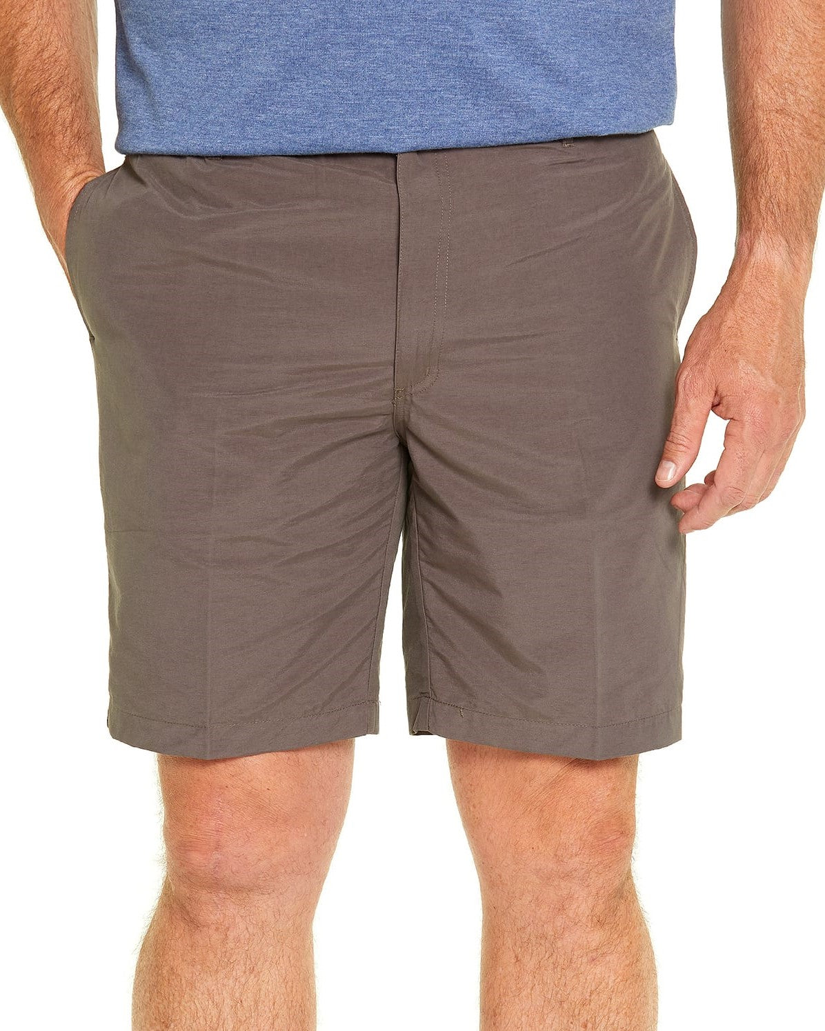 A person in a blue shirt and Breakaway Woodbury Short with elastic waist stands against a white background, one hand in pocket. Made from polyester nylon fabric, the shorts have a smooth texture and fitted look.