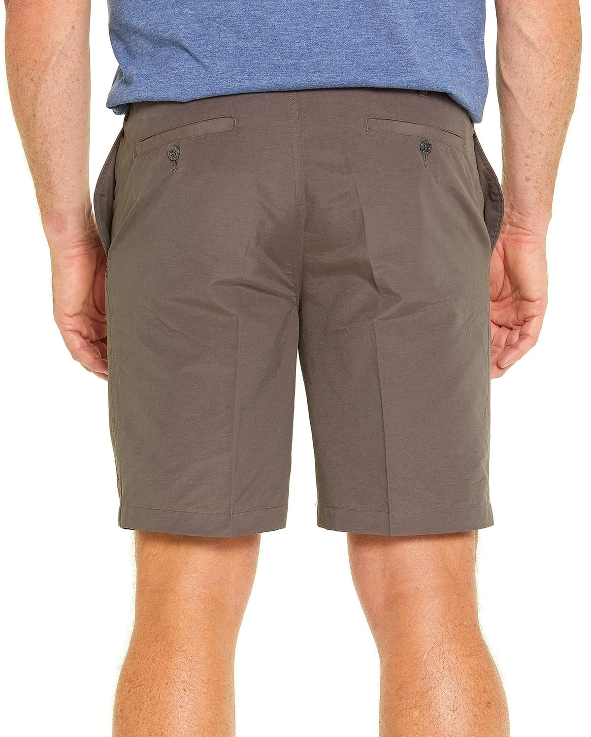 A person wearing a blue shirt and Breakaway Woodbury Shorts in brown stands against a plain white background. The comfortable shorts, made from a polyester nylon blend, have an elastic waist and two back pockets with button closures. The person's arms rest at their sides.