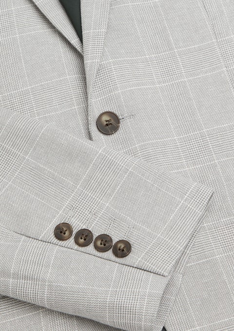 Close-up of the Connor Sorrento Slim Suit Jacket in light gray plaid with brown sleeve and front buttons, styled with the sleeve neatly folded over the body for a sharp, modern look.