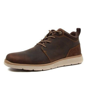 The Colorado Yarra Casual Boot is a brown leather sneaker with a white rubber sole and brown laces. It features a low-top design, a padded collar, and a pull tab at the heel. The slip-resistant outsole boasts a textured pattern for enhanced grip.
