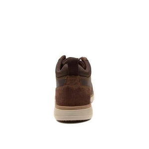 Rear view of the Colorado Yarra Casual Boot, showcasing a blend of suede and leather textures. The shoe features a white sole with a beige accent, brown laces, and a back pull-tab. Slip-resistant outsoles and memory foam insoles provide enhanced comfort, while the lighting emphasizes the variety of materials used on the upper.