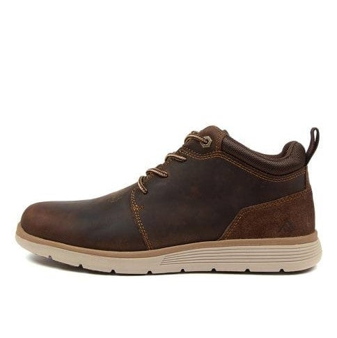 The Colorado Yarra Casual Boot is a brown leather chukka with a beige rubber sole, featuring three pairs of eyelets, brown laces, and a pull tab at the heel. The minimalist design includes memory foam insoles and a slightly padded collar for comfort.