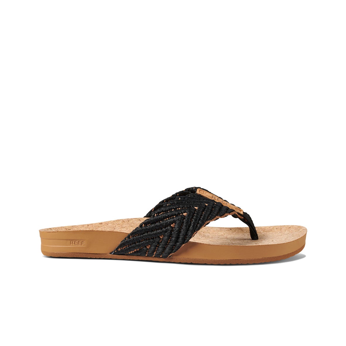 The REEF Cushion Strand is a black woven sandal with a cork footbed, brown rubber sole, and thong strap design. It features an EVA foam cushion bounce midsole and a slight wedge for enhanced comfort.