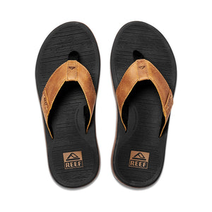 The REEF Santa Ana LE sandals feature black soles with brown leather straps, adorned with the REEF logo. Designed with a toe post and textured footbed for ultimate comfort and arch support, they blend casual style and durability seamlessly. Ideal for any occasion, these water-friendly sandals are perfect for your aquatic adventures.