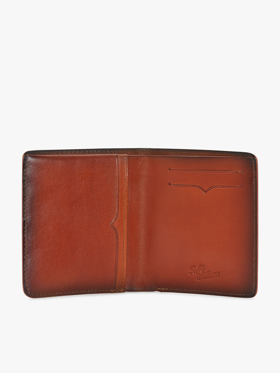 Open the RM Williams Urban Bi-Fold wallet in brown full grain leather with two card slots, a receipt pocket, and embossed branding. This polished bi-fold design offers a smooth finish on both interior panels.