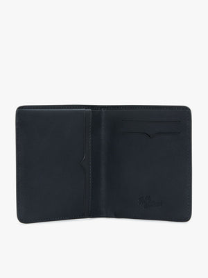 The RM Williams Urban Bi-Fold wallet, crafted from full grain leather, features multiple compartments including a large pocket on the left and two card slots on the right. The inside boasts a subtle embossed signature near the bottom right corner. The wallet is set against a plain white background.