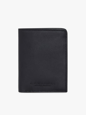 A closed, black RM Williams Urban Small Slim Tri-Fold wallet in full grain leather with subtle stitching and the RM Williams logo embossed on the front, displayed against a plain white background.