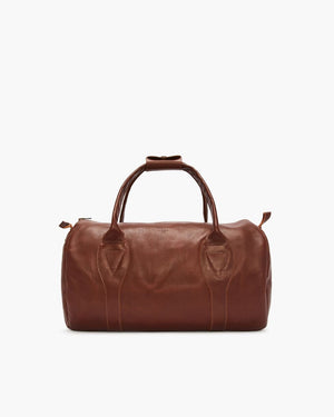 The RM Williams Leather Ute Bag in brown features two handles and a detachable shoulder strap, shown against a plain white background.