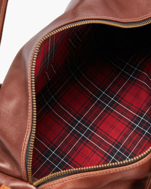Close-up view of the RM Williams Leather Ute Bag, Australian Made, with interior red and black plaid fabric lining visible.