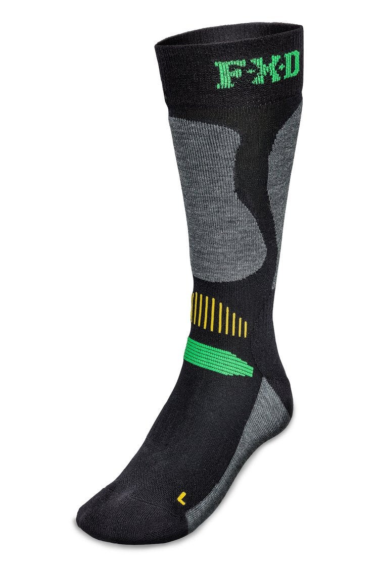 A single dark-colored, crew-length sock from the FXD SK-7 Tech Sock 2 Pack features green and yellow accents, a grey heel and toe area, and an ergonomic design. The ribbed band at the top is adorned with "FXD" in green, while the arch showcases green stripes and a bold green rectangle. This sock also includes moisture-wicking properties for enhanced comfort.