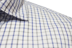 The Back Bay Bamboo Soft Touch Short Sleeve Shirt showcases a grid pattern with thin blue and thicker black lines. Its white fabric is a crisp Bamboo/Polyester blend, featuring a collar for versatility and short sleeves for a relaxed vibe.