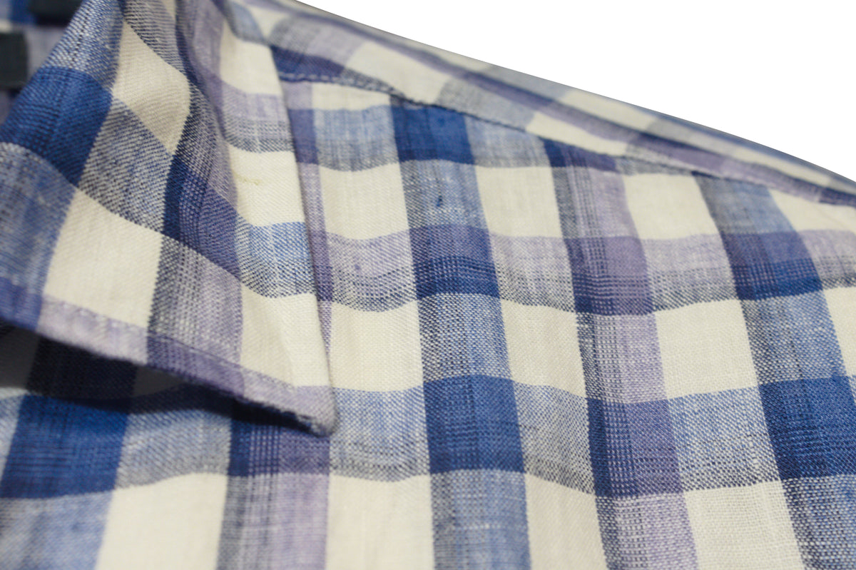 Close-up of the Back Bay Linen Check Short Sleeve Shirt in blue and white plaid, highlighting the fabric's texture. The design features intersecting blue, white, and light purple lines with a slightly visible collar on the left side, adding elegance to its classic style.