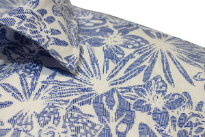 Close-up of the Back Bay Linen Print Short Sleeve Shirt, showcasing a blue and white floral pattern with leaves and flowers. The linen fabric highlights an intricate design, with short sleeves and part of the collar visible.